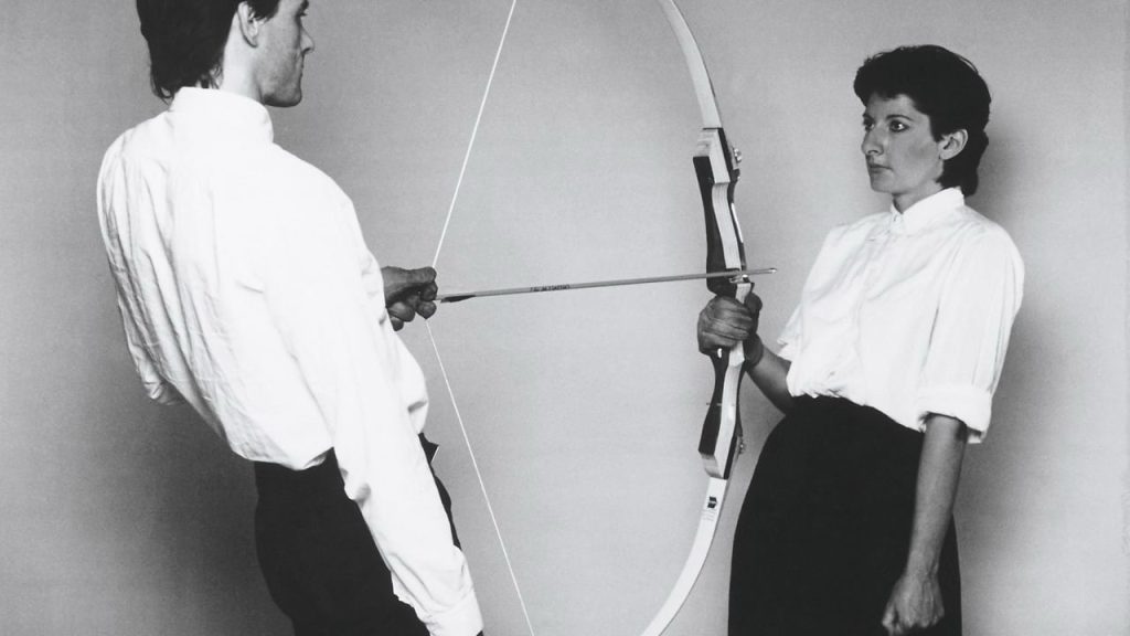 Marina Abramovic, Rest Energy, 1980​. In the picture, Abramovic is holding a bow while her partner at the time, Ulay was holding the arrow, at Abramovic.